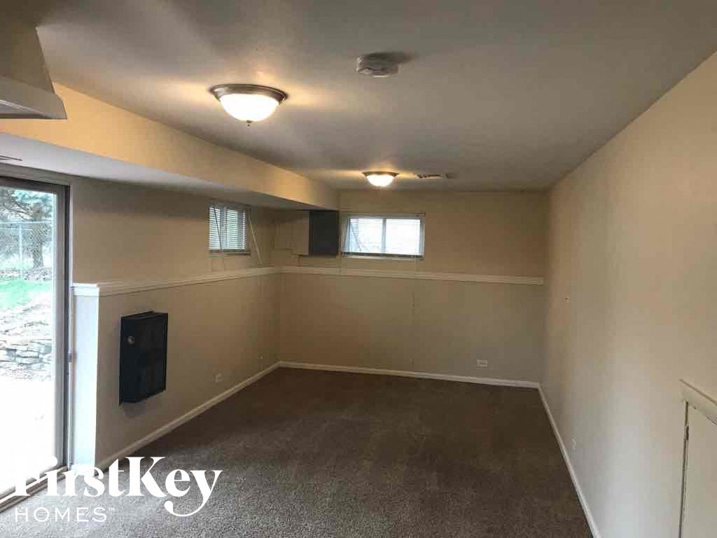 an empty living room with a window and a door