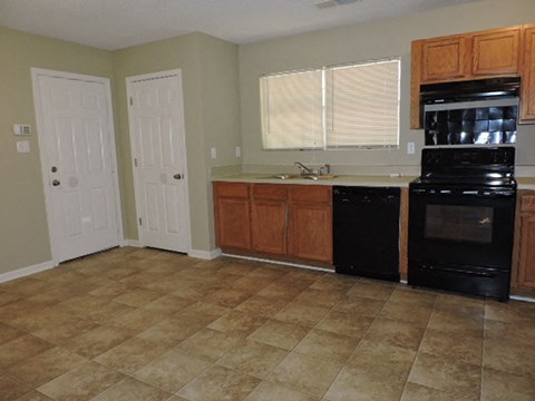 a kitchen with a stove a sink and a refrigerator