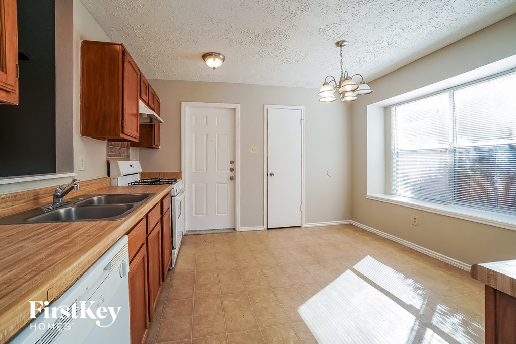 an empty kitchen with a sink and a window