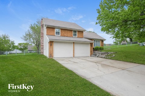 a home with a white garage door and a driveway