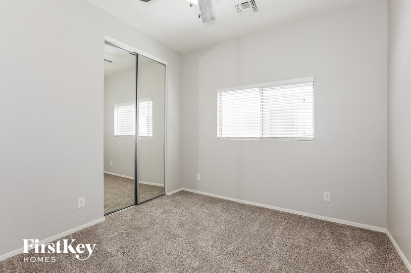 a bedroom with a mirror and a carpeted floor