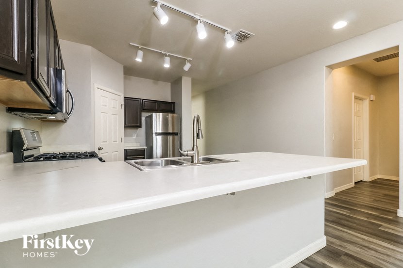 A modern kitchen with a FirstKey Homes logo.