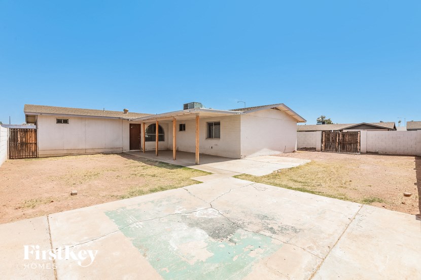 a white house with a yard and a fence