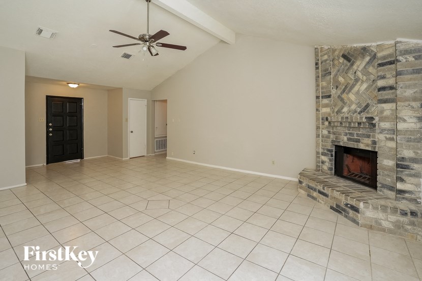 a living room with a fireplace and a tile floor