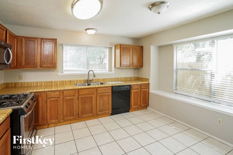 a kitchen with wooden cabinets and a sink and a window