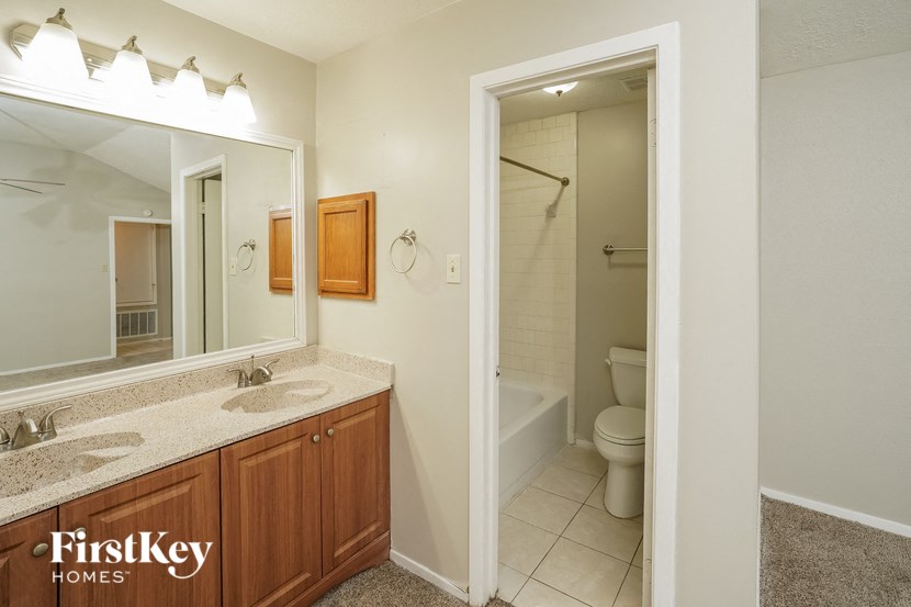 a bathroom with a toilet and a sink and a mirror