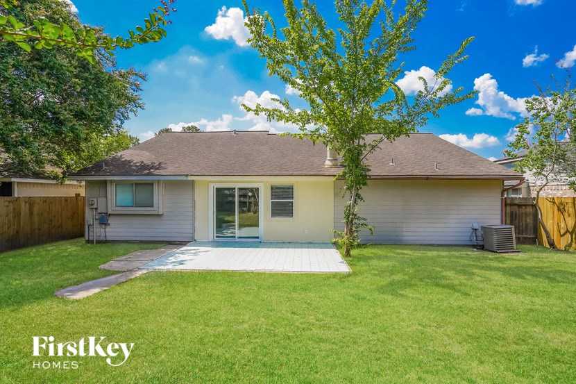 a white house with a yard and a tree