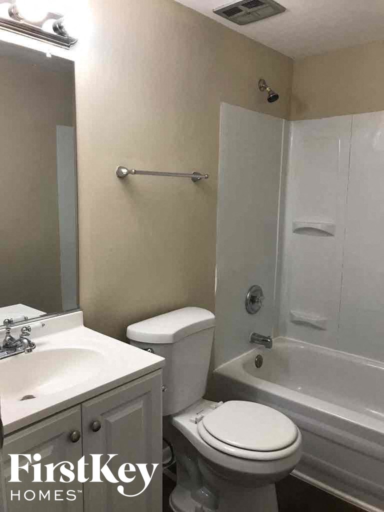 a bathroom with a sink toilet and a shower