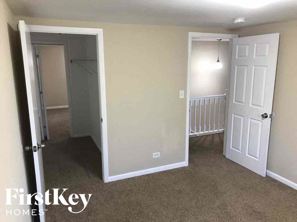an empty room with a closet and a white door