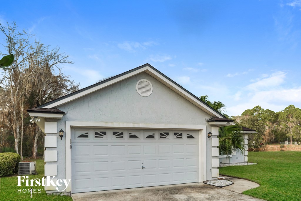 A two-car garage with a FirstKey Homes logo.