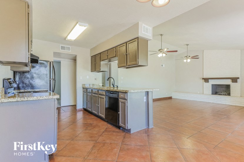 a kitchen and living room with a stove and a refrigerator