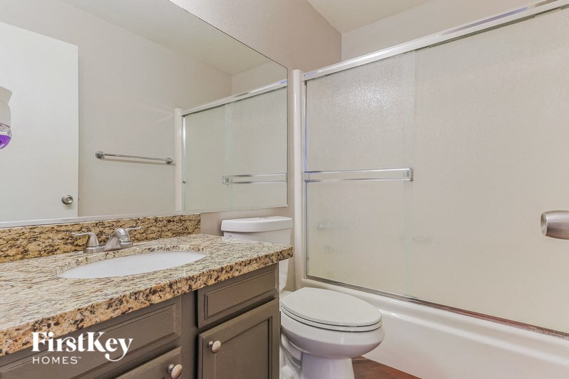 a bathroom with a sink toilet and a shower