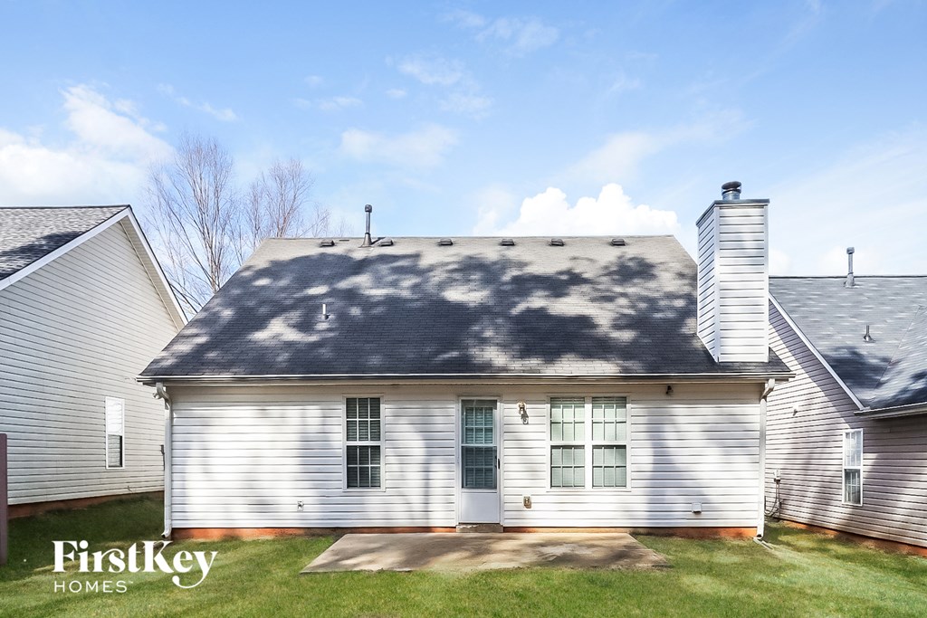 the front of a white house with a gray roof