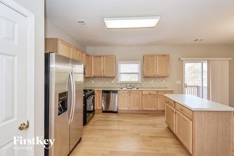 a kitchen with wooden cabinets and stainless steel appliances