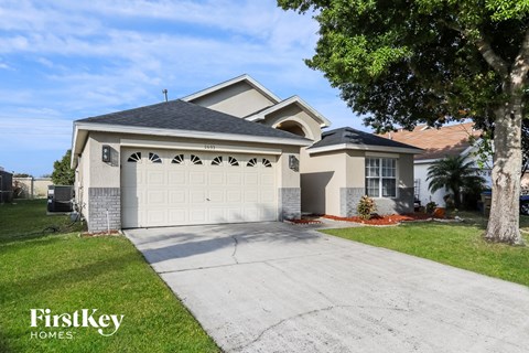 A house with a garage and a driveway is for sale.