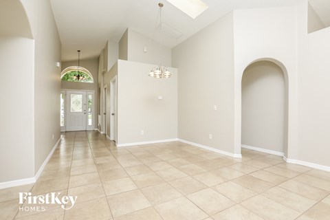 A spacious room with a skylight and a chandelier.