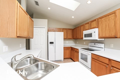 A kitchen with wooden cabinets and stainless steel appliances.