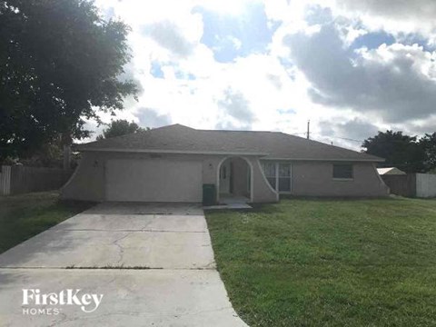 A house with a driveway in front of it.