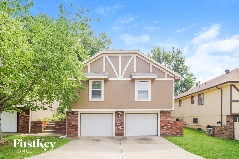 a beige house with a white garage door