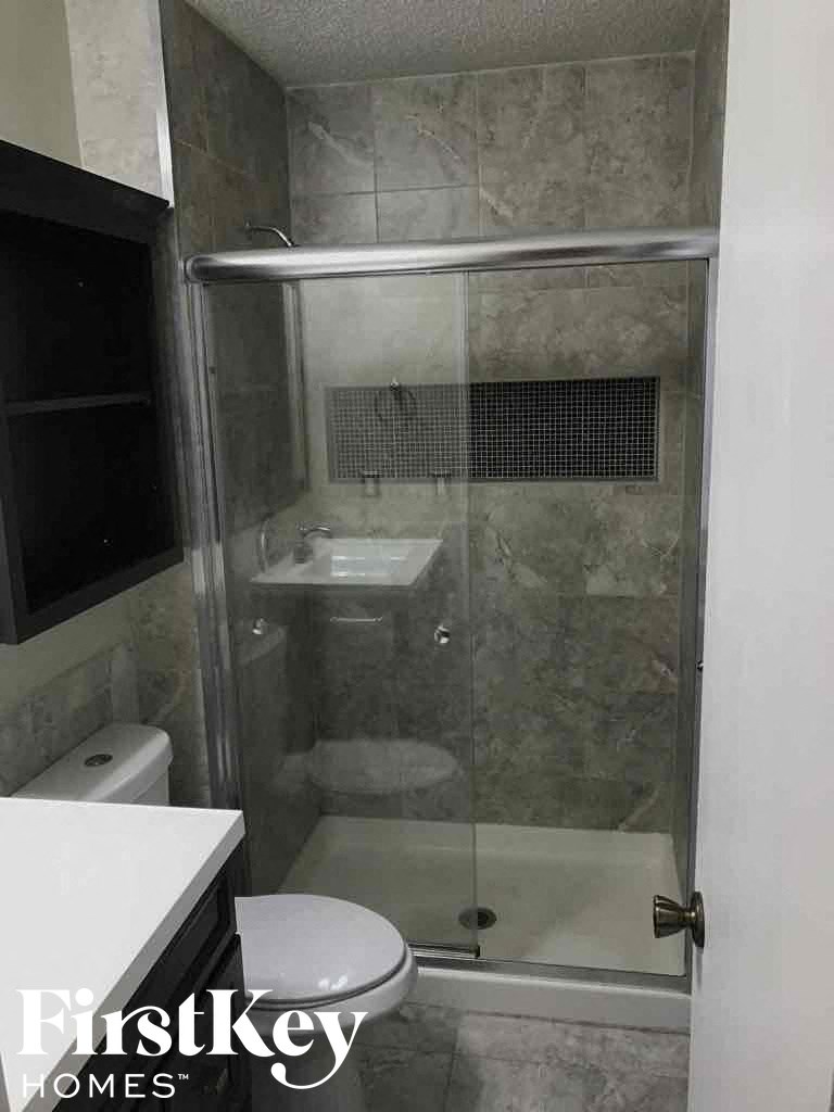 a small bathroom with a shower and a toilet