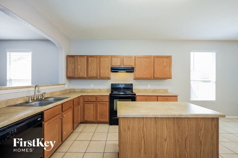 A kitchen with wooden cabinets and a countertop.