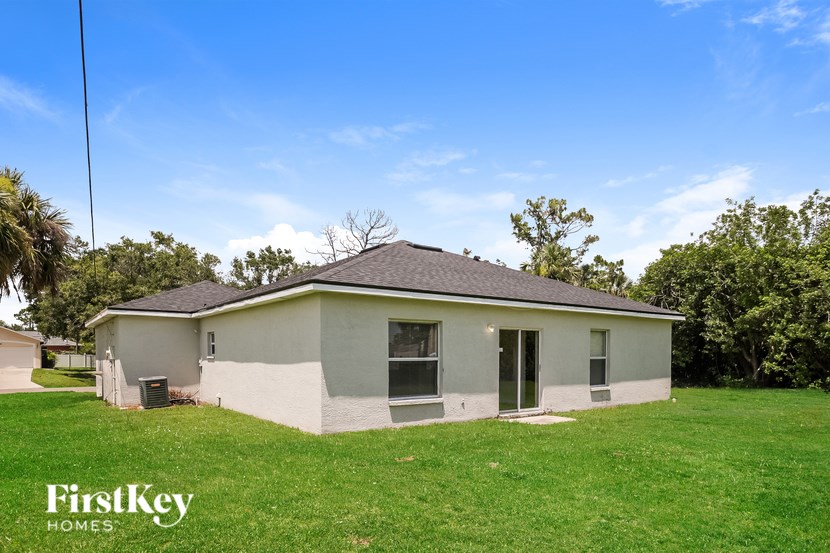 A house with a grassy lawn and a clear blue sky.