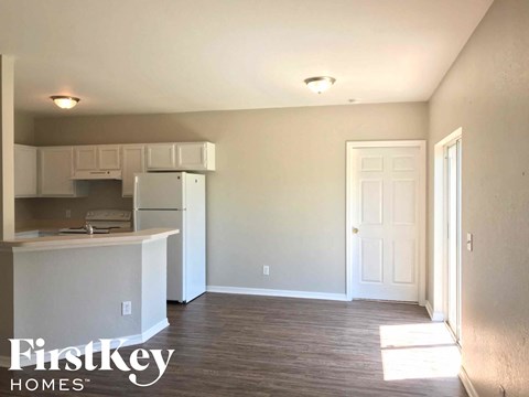 a kitchen with white cabinets and a white refrigerator