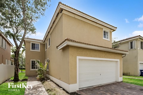 a beige house with a white garage door