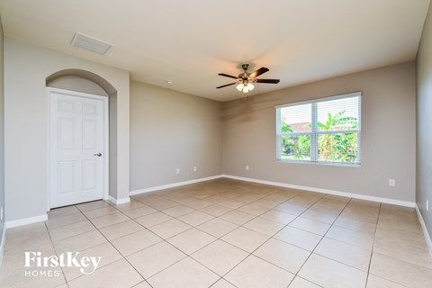 A spacious room with a ceiling fan and a window.