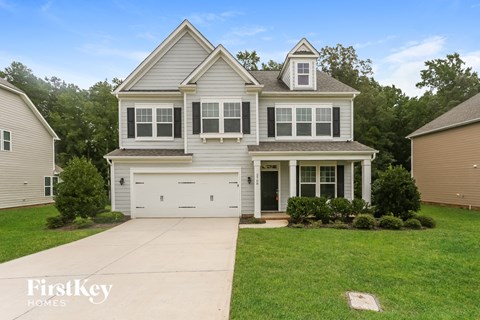 A two-story house with a garage is for sale.