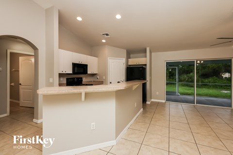 A spacious kitchen with a countertop and a microwave.