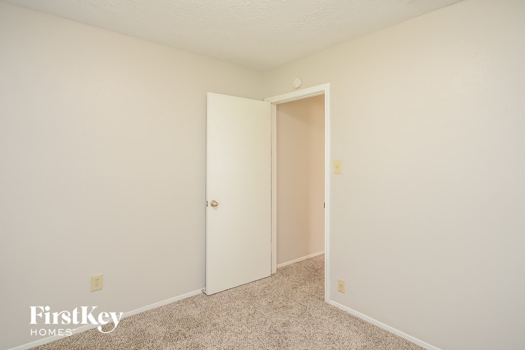 a bedroom with a closet and an open door