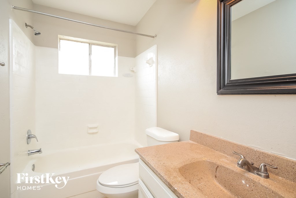 a bathroom with a sink and a toilet and a bath tub
