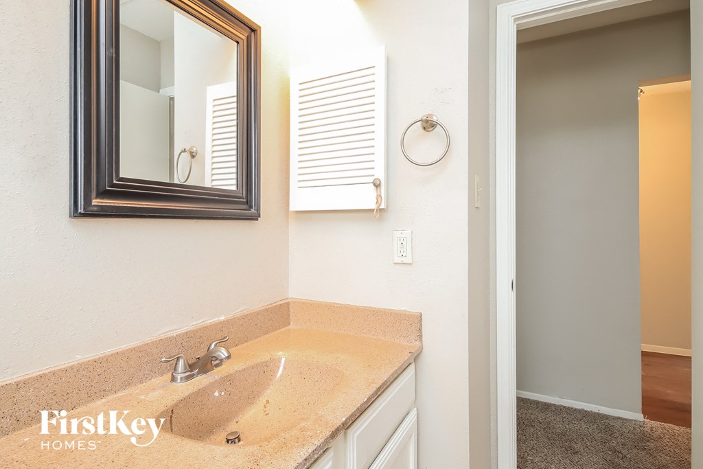 a bathroom with a sink and a mirror on the wall