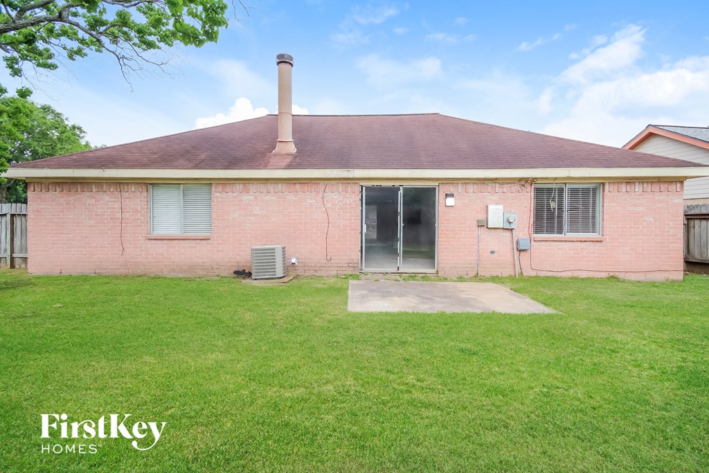 an old brick house with a yard and grass