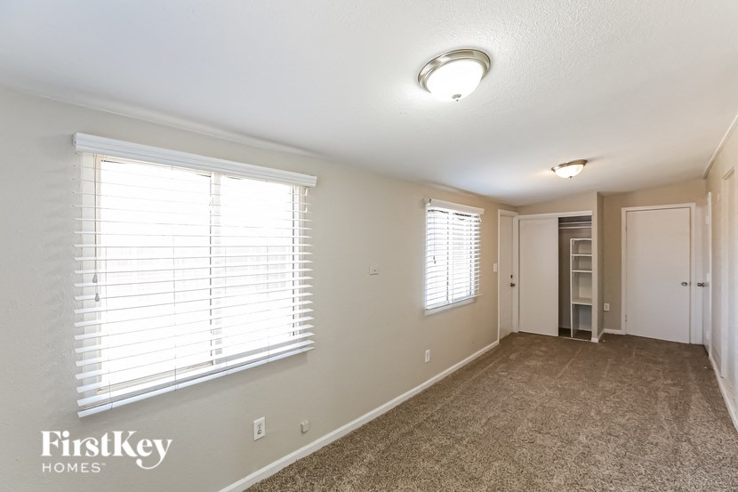 the living room of an empty house with a large window