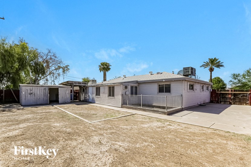 a white house with a yard and a garage