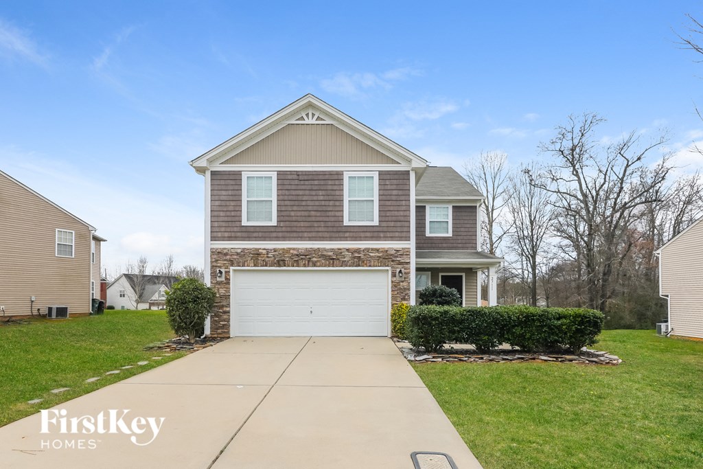 A two-story house with a garage is for sale.