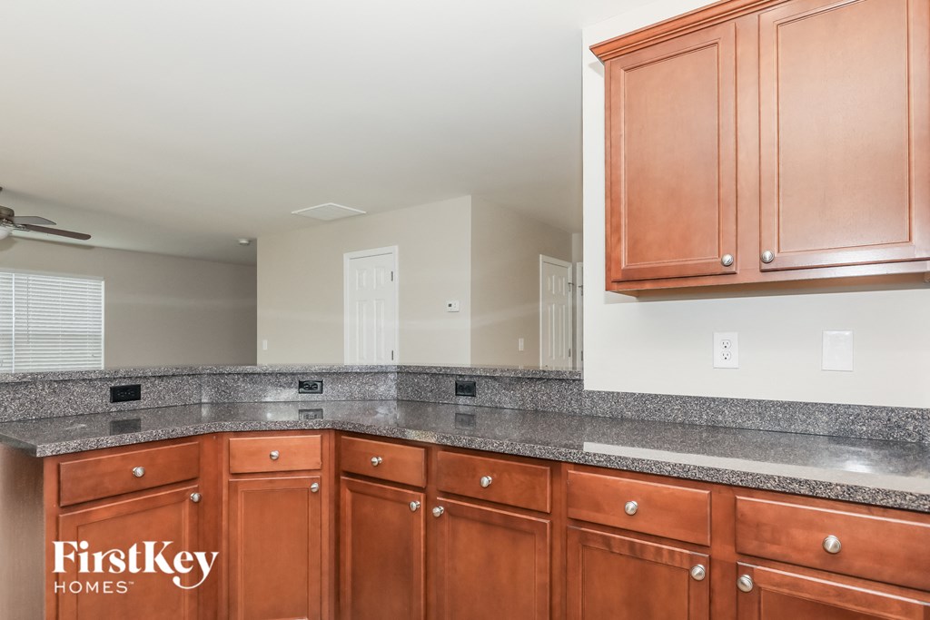 A kitchen with brown cabinets and a countertop.