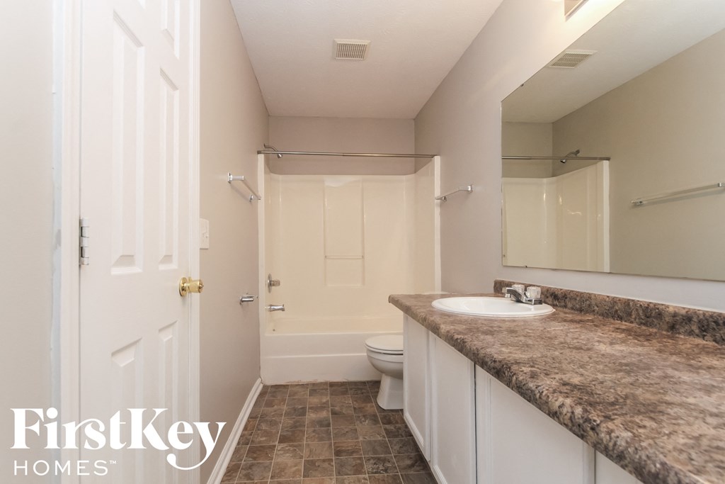a bathroom with a sink and a toilet and a shower