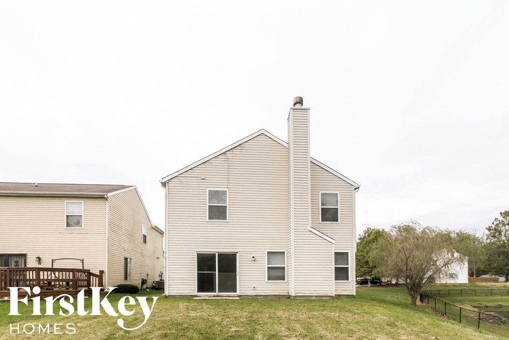 a white house with a yard in front of it