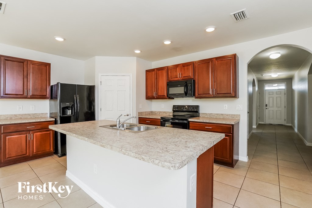 a kitchen with a marble counter top and a sink