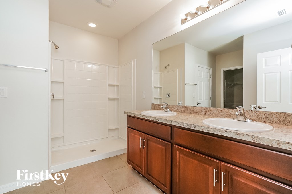 a bathroom with two sinks and a large mirror