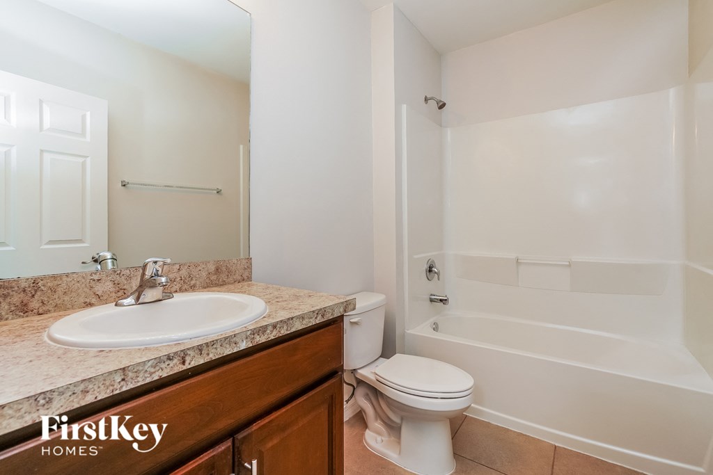 a bathroom with a sink toilet and a shower