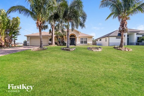 a house with palm trees in front of it