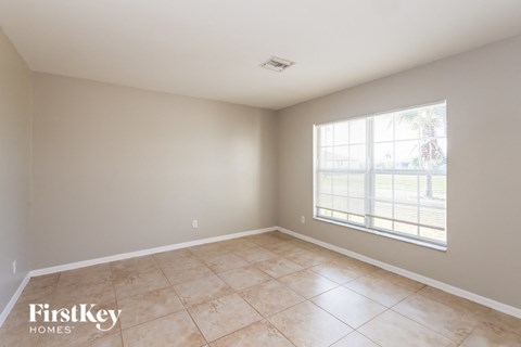 the living room of an empty home with a large window