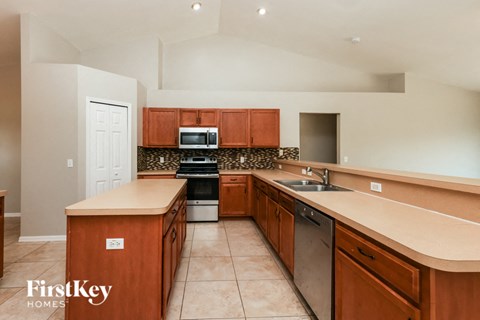 a kitchen with wooden cabinets and stainless steel appliances