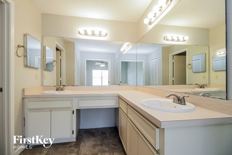 a large bathroom with two sinks and a large mirror