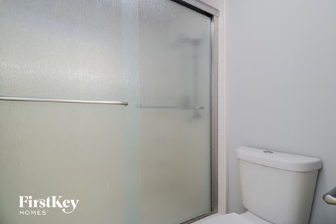 a small bathroom with a shower and a toilet