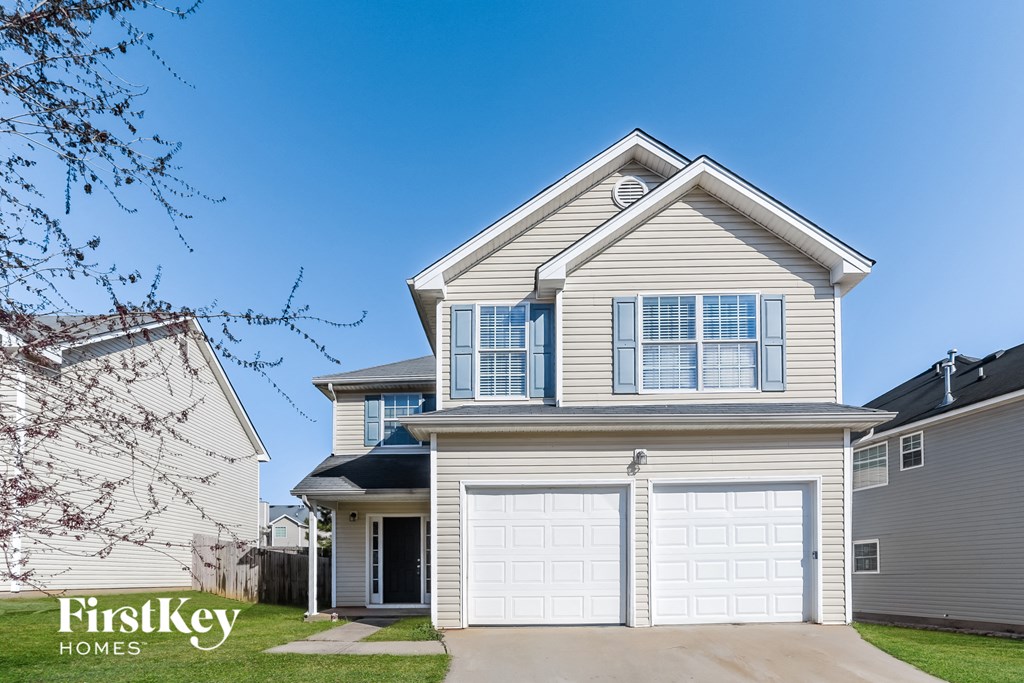 a white house with a white garage door